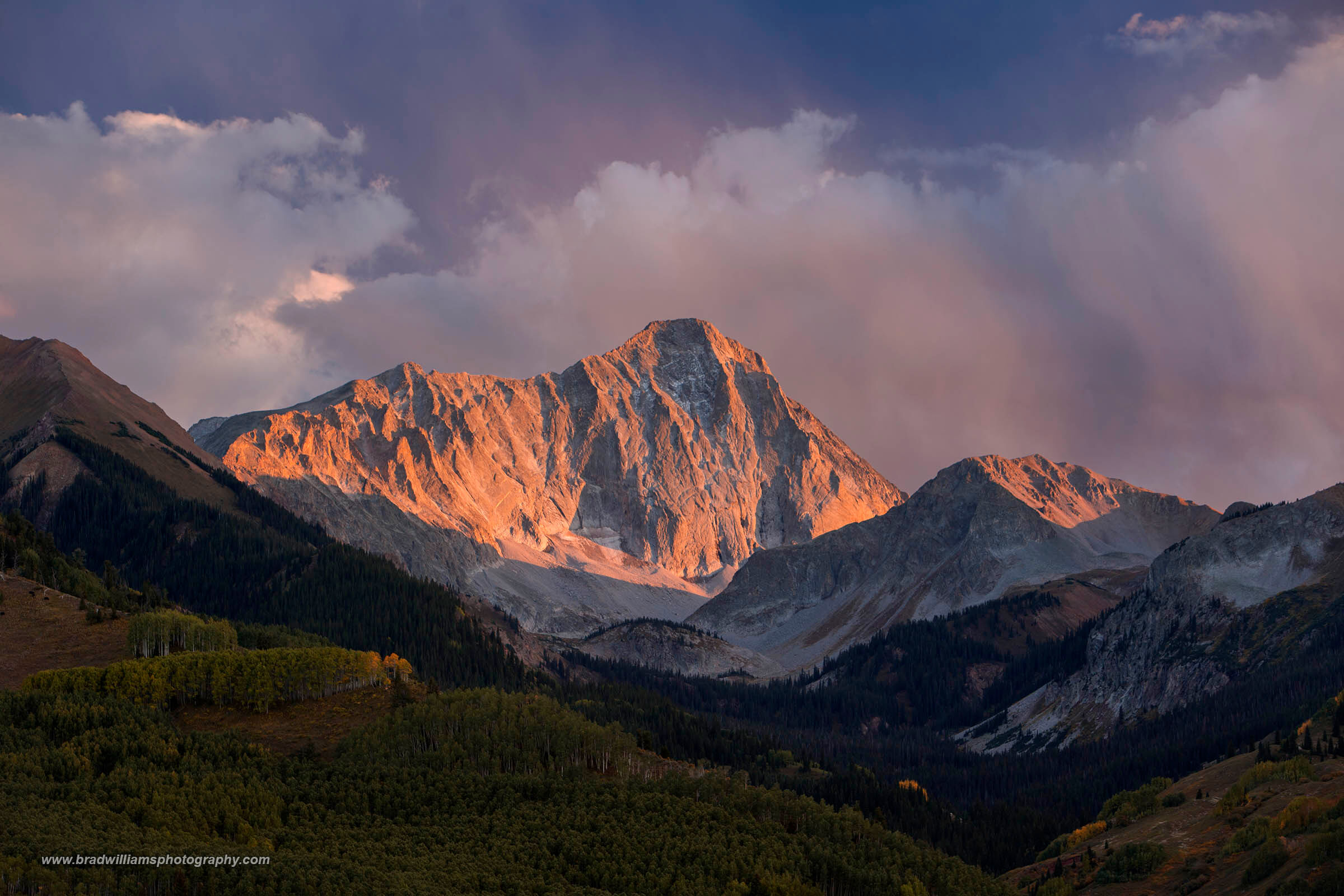 A beautiful warm sunset light reflecting off Capitol Peak in the Elk Mountains, White River National Forest,  Colorado.